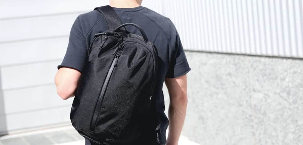 a person carrying a black Aer Fit Pack