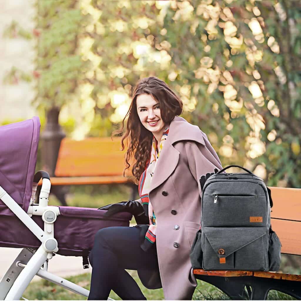 a mother having a black HapTim Multi-Function Diaper Bag Backpack 