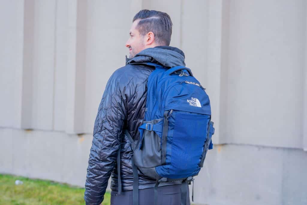 a man carrying a North Face Recon Backpack