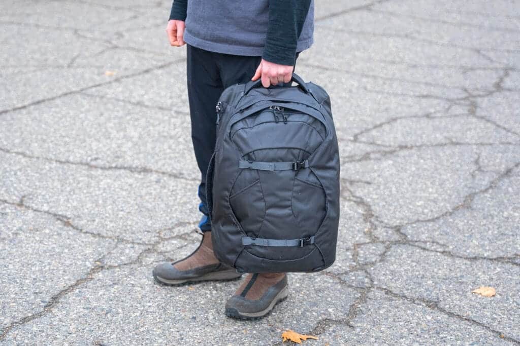 person carrying a black Osprey Farpoint