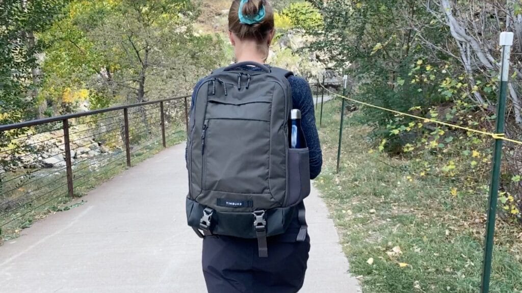 a girl carrying a dark grey Timbuk Authority Laptop Backpack