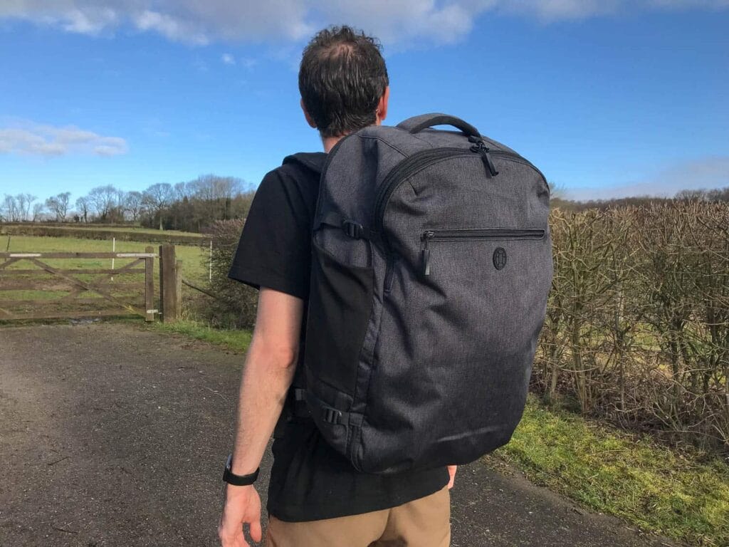 a person carrying a black Tortuga Setout Backpack