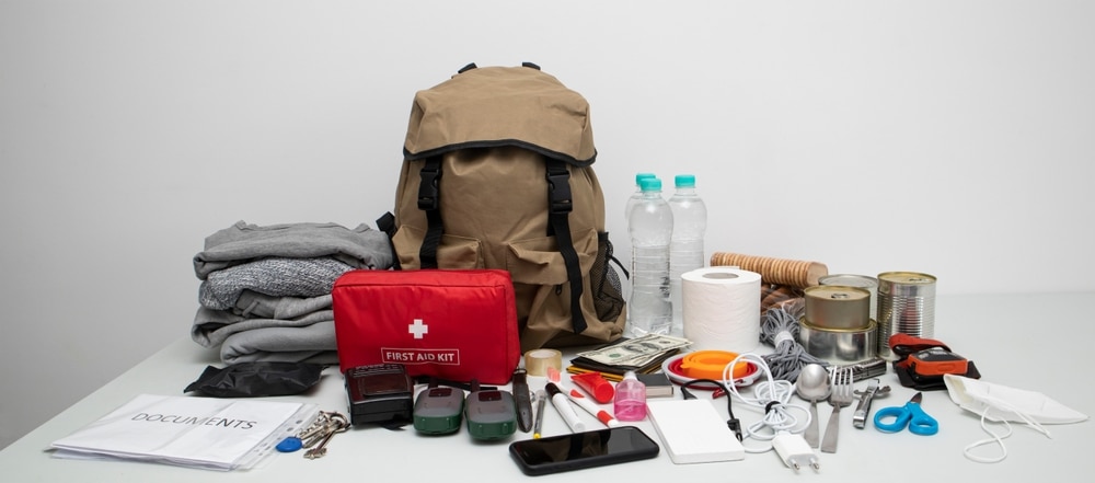 Emergency Backpack Equipment Organized On The Table Documents Water food First