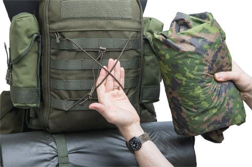 a man showing bungee cords of backpack 