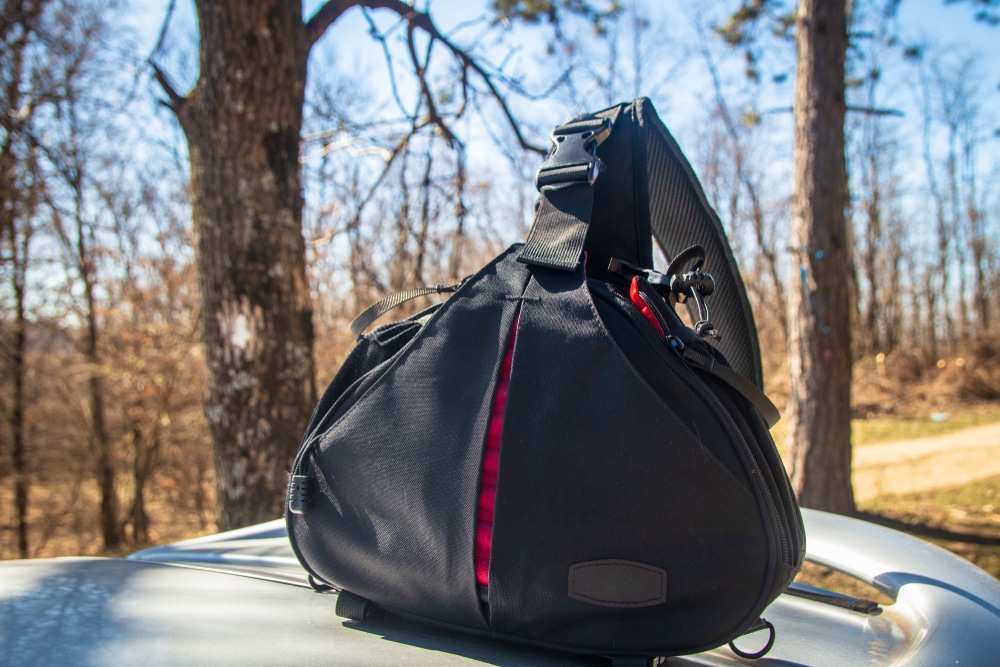 Black Sling Bag For Camera And Accessories On Roof Of