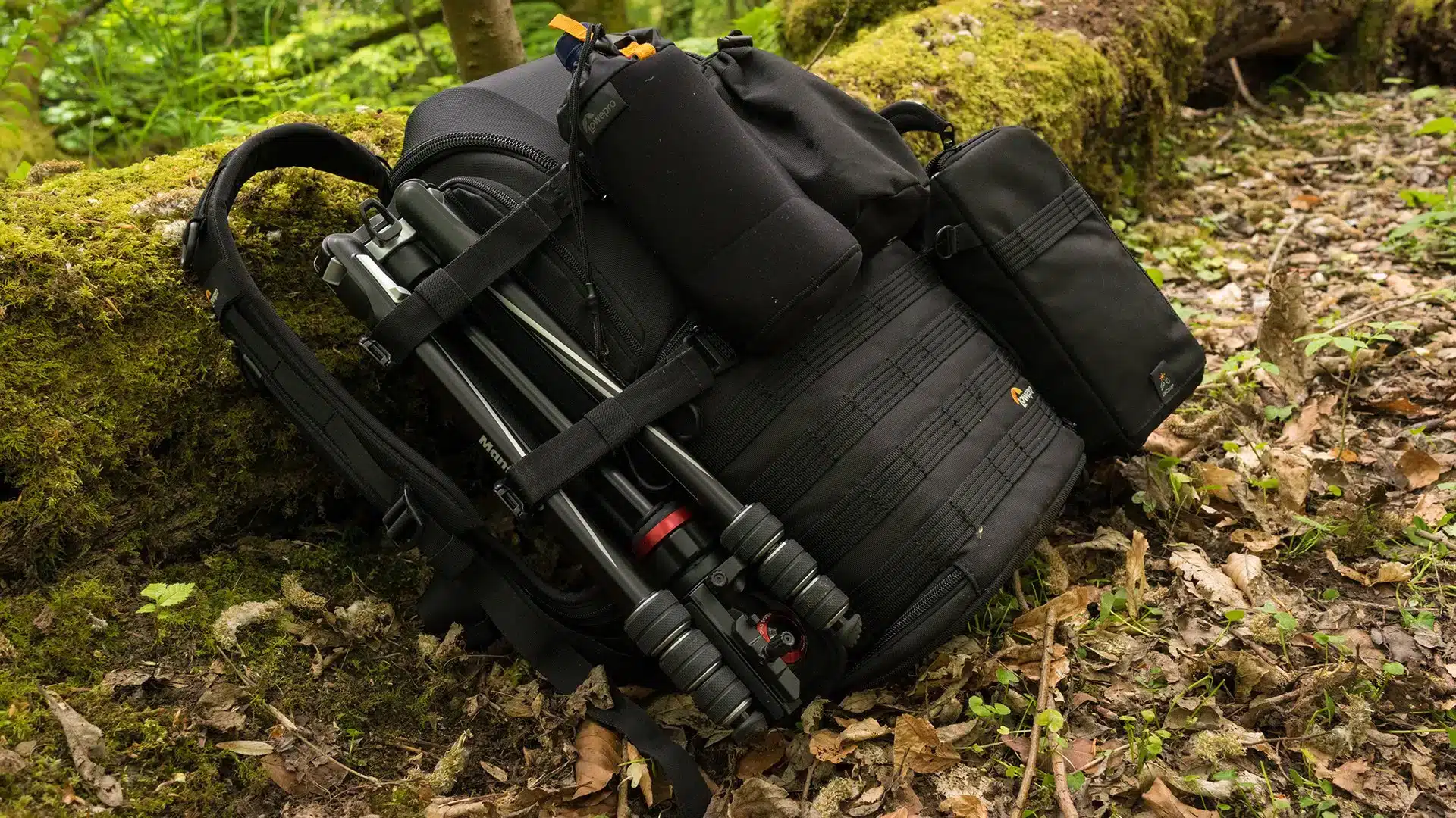 Lowepro ProTactic AW II lying in the forest with shooting essentials attached outside