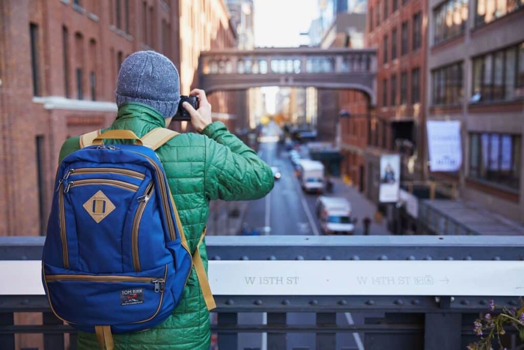 a person wearingTOM BIHN SYNAPSE standing on a bridge