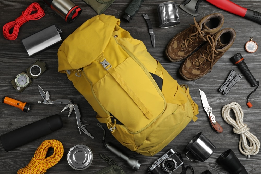 Flat Lay Composition With Different Camping Equipment On Dark Wooden