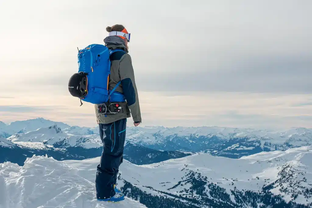 a man standing on top of mountain wearing Ortovox Haute Route