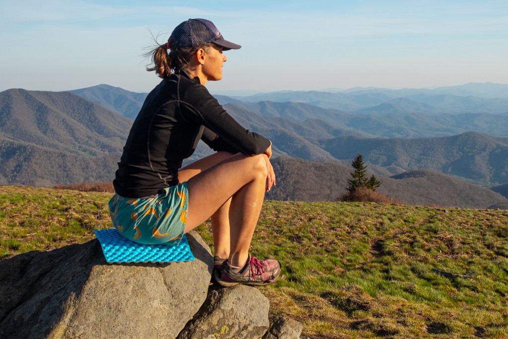 a lasy sitting on Rest Z Seat on a stone