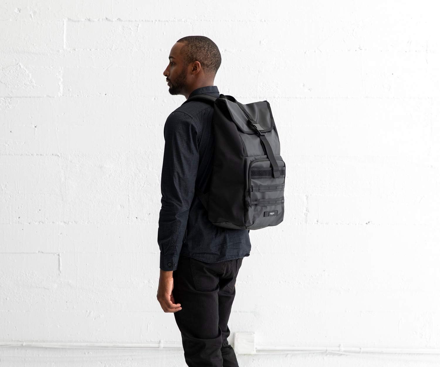 a man wearing a Timbuk Spire Laptop Backpack  