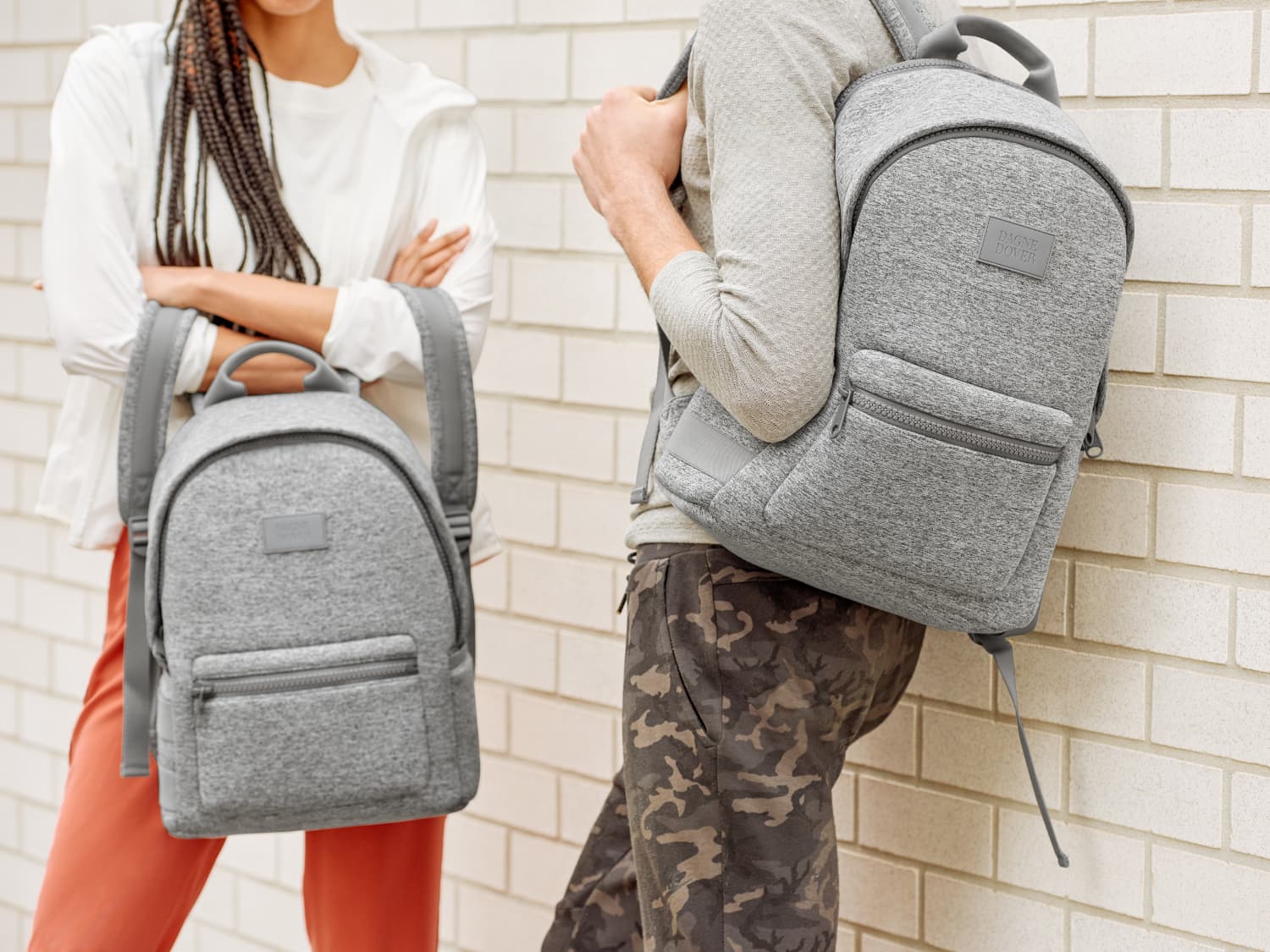 Half view of a girl and a boy holding dakota dover backpack Half view of a girl and a boy holding dakota dover backpack