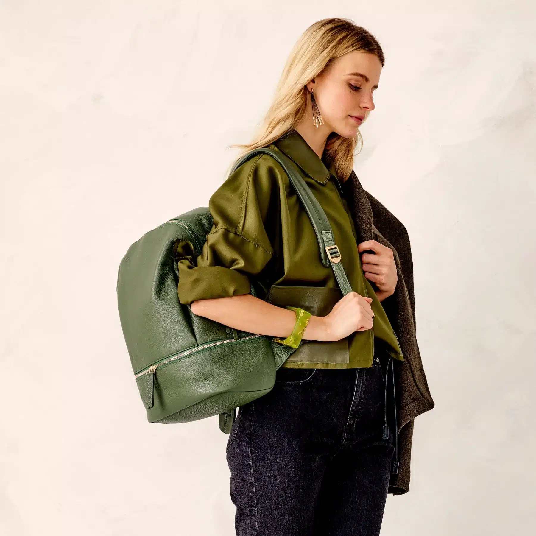 a woman carrying vera bradley backpack in green color a woman carrying vera bradley backpack in green color