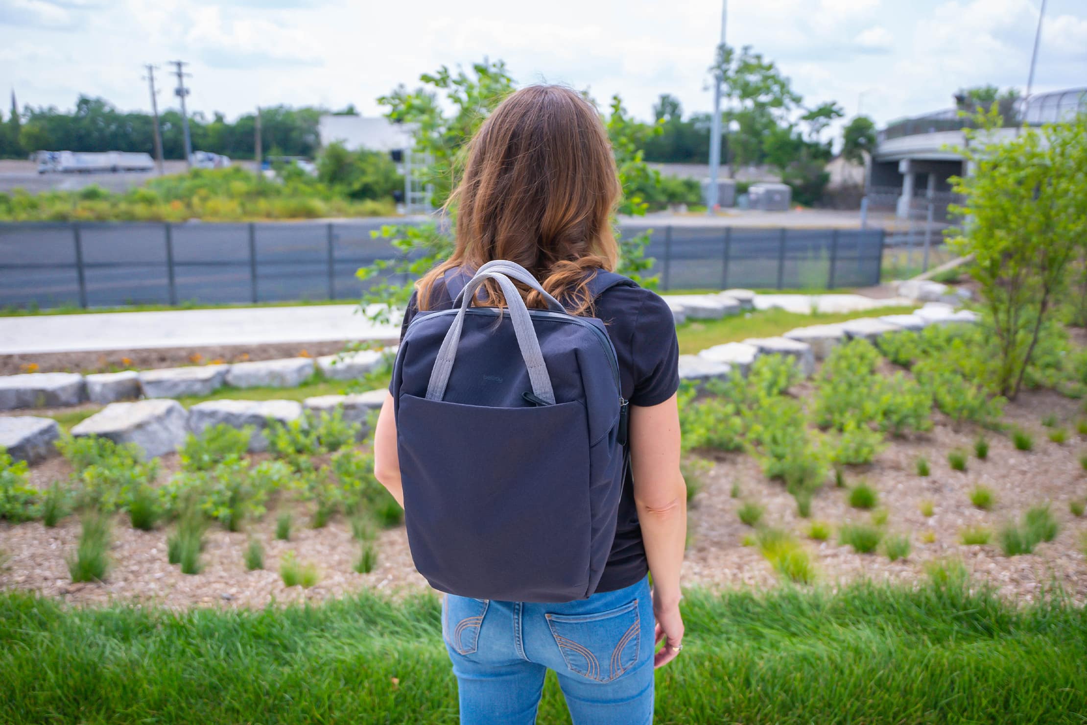 back of a woman wearing bellroy backpack back of a woman wearing bellroy backpack