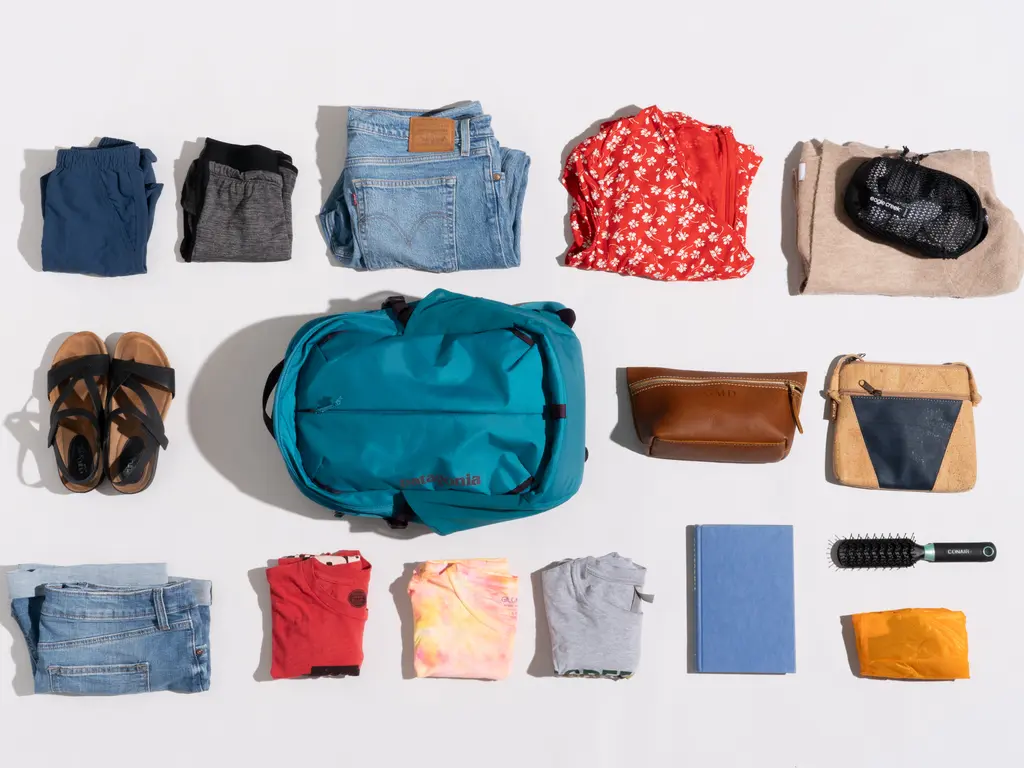 different clothing items on a clean background and a backpack different clothing items on a clean background and a backpack