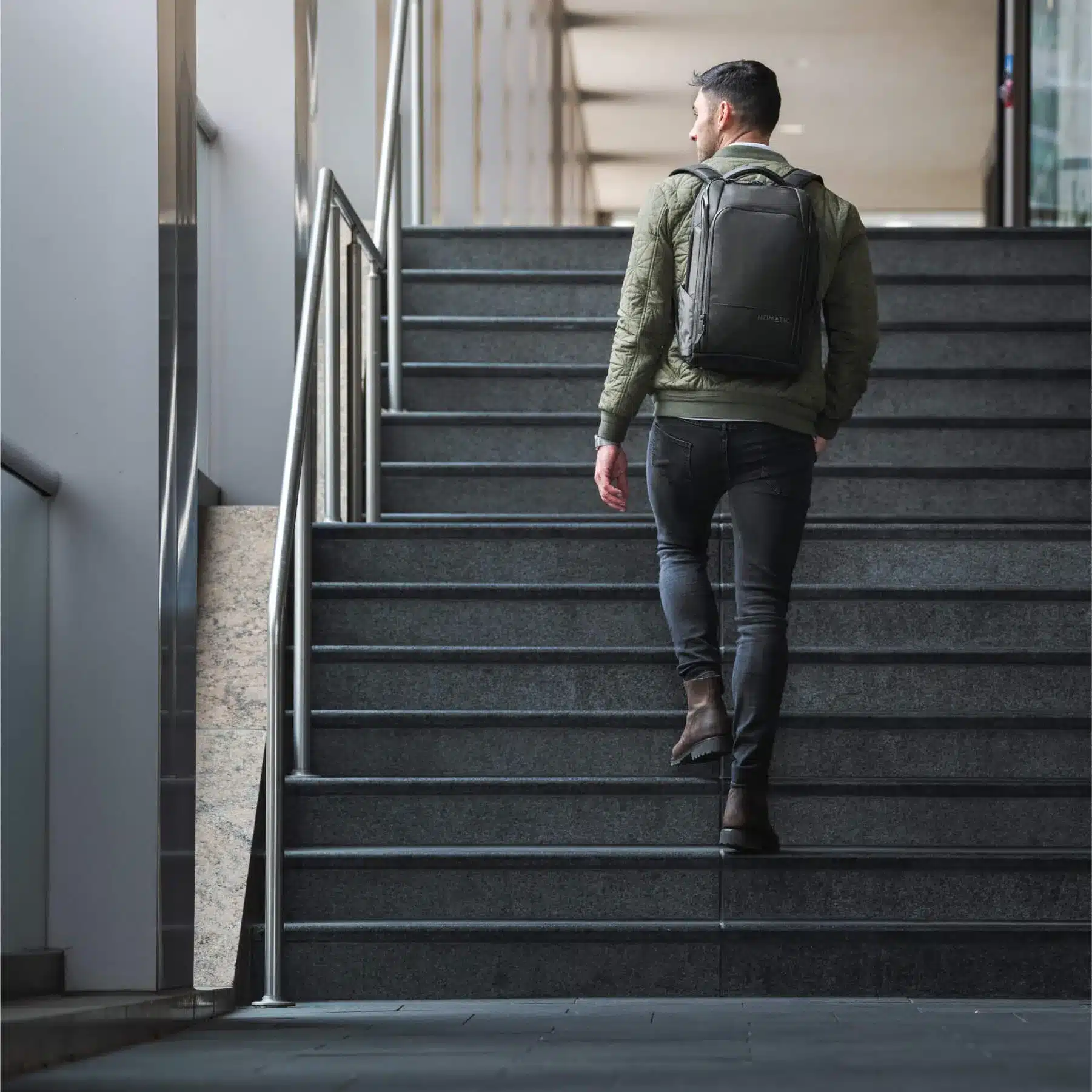 back of a boy wearing nomatic travel backpack back of a boy wearing nomatic travel backpack