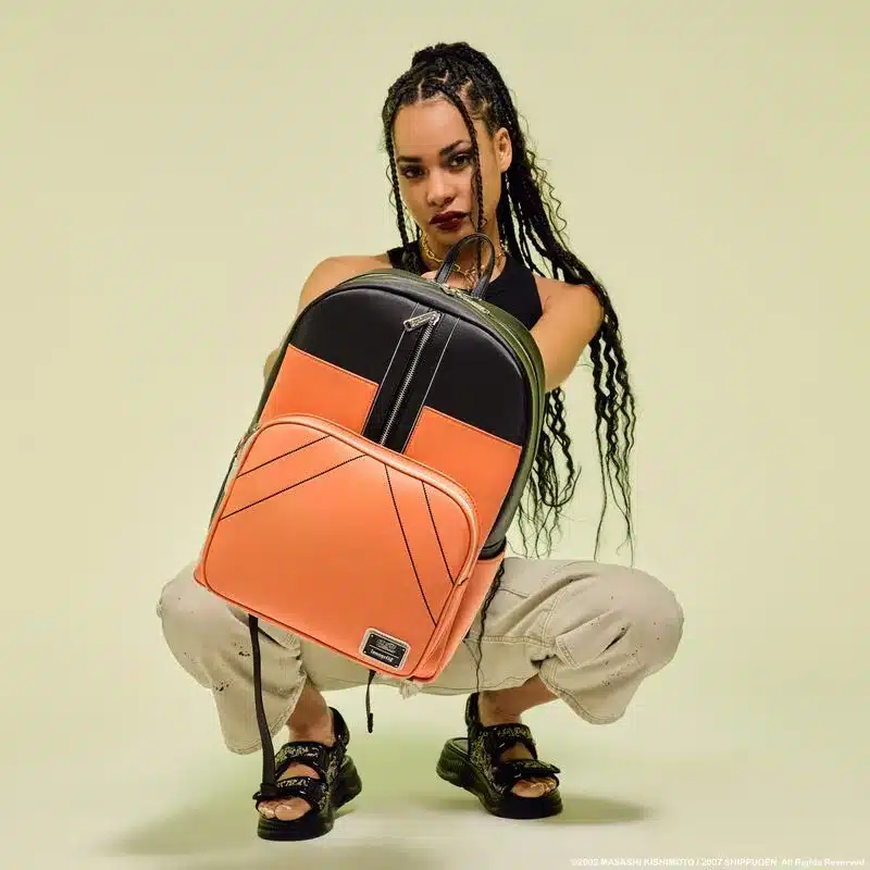 a girl holding Loungefly Naruto Cosplay Full‑Size Backpack sitting a a ground