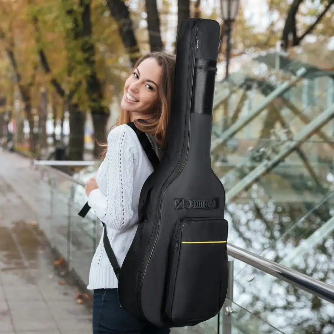 a girl smiling wearing a backpack for guitar a girl smiling wearing a backpack for guitar