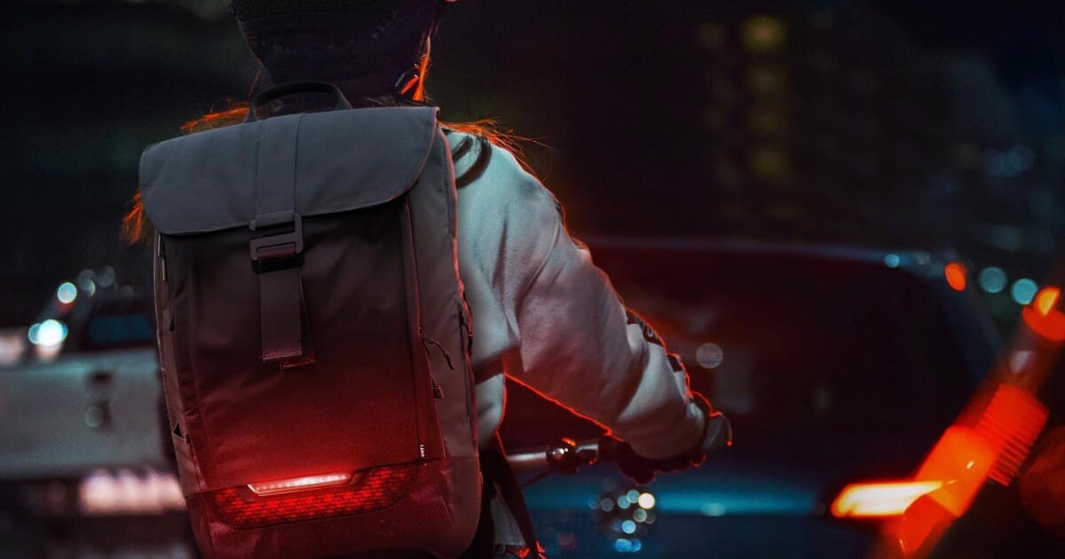 back of a boy wearing an LED backpack in red color back of a boy wearing an LED backpack in red color